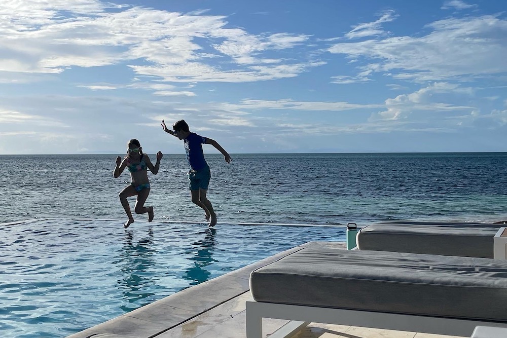 Children jumping into pool at Manta Island.