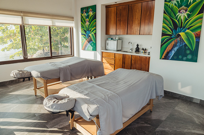 Sunlit Tranquil Tides spa at Manta Island Resort with two massage beds.