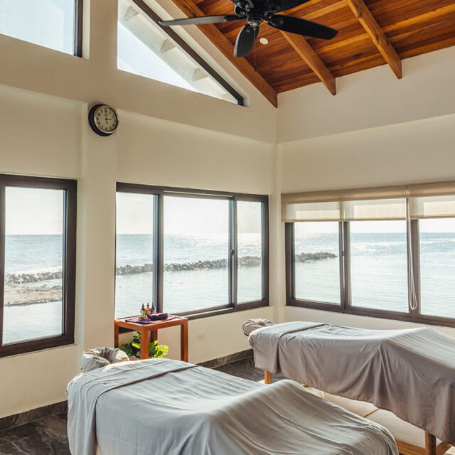 Two massage tables overlooking the scenic reef at Manta Island Resort.