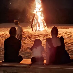 Family watching bonfire